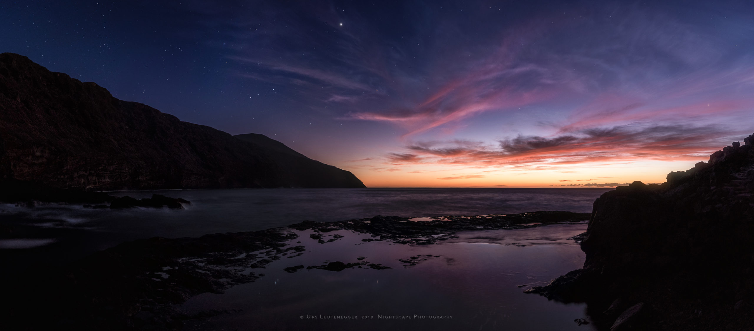 Autumn dusk sky on La Palma. Orange-pink clouds, Jupiter in Scorpius.